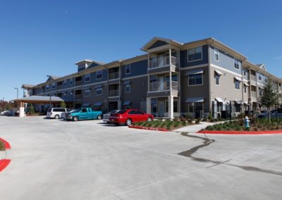 Exterior view of Floral Gardens Senior Apartments from the parking lot